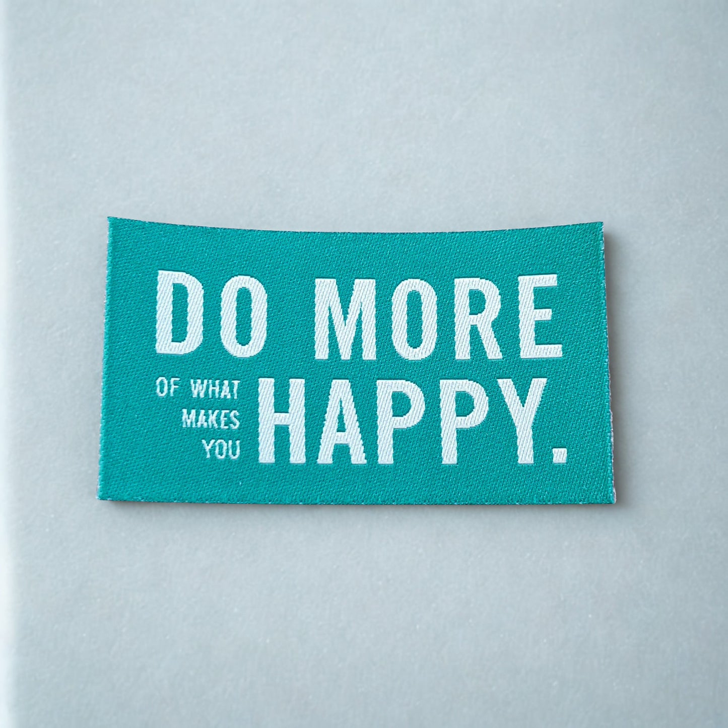 Aufbügelbare Weblabel von Prülla „Do more of what makes you happy“ in 4 Farben 4x7 cm